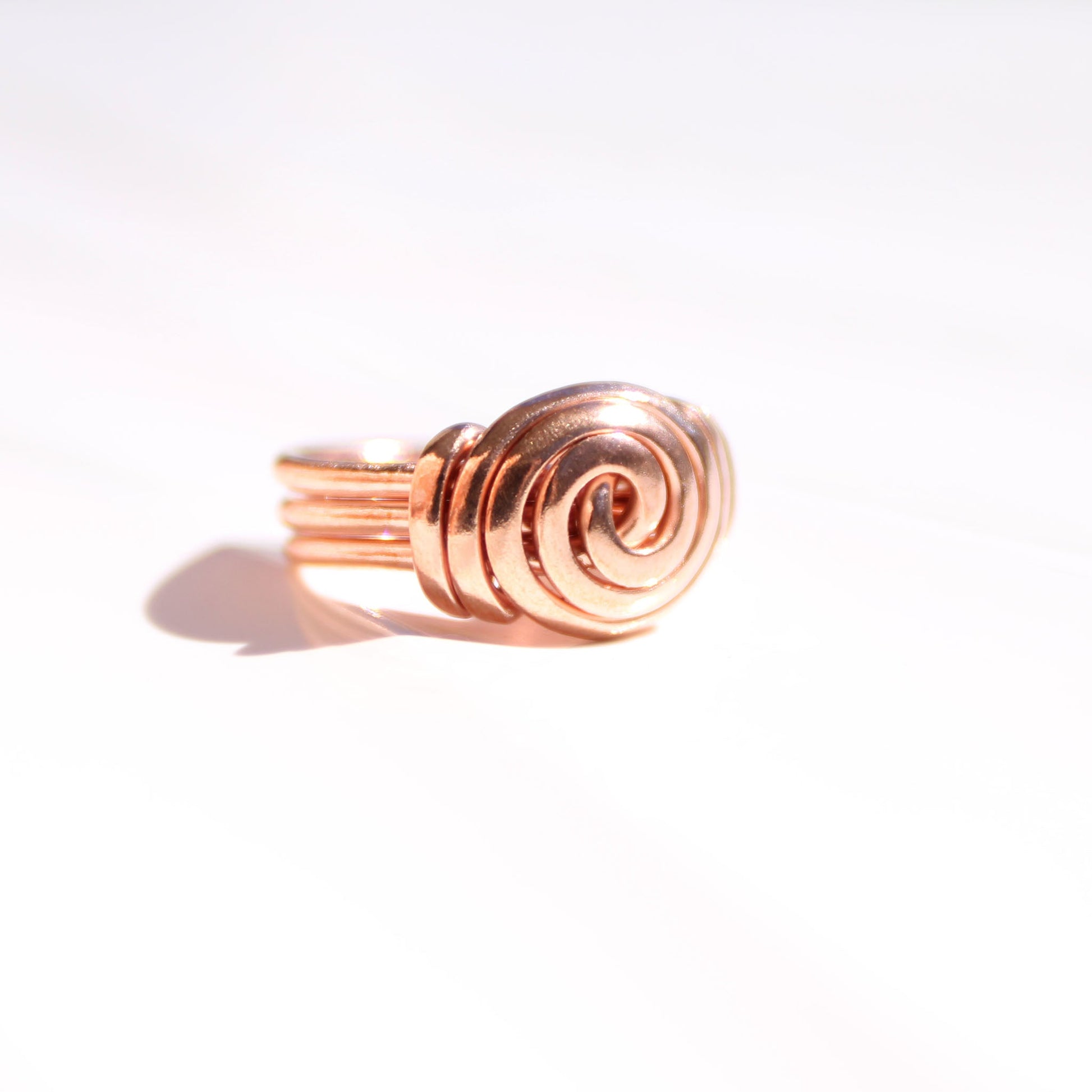 Bold copper statement ring worn on finger - Wide band spiral design
