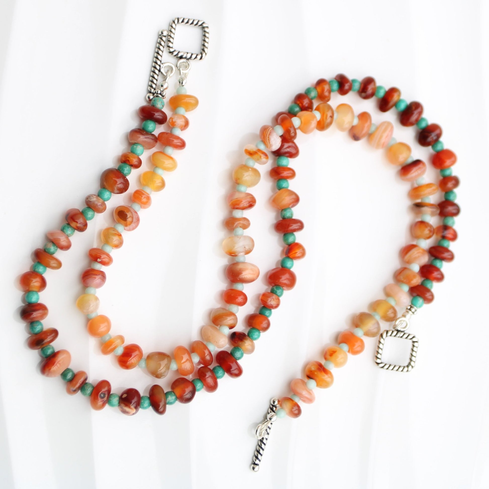 Light red botswana agate donut style beads accented with amazonite handmade in virginia carrie foscato design