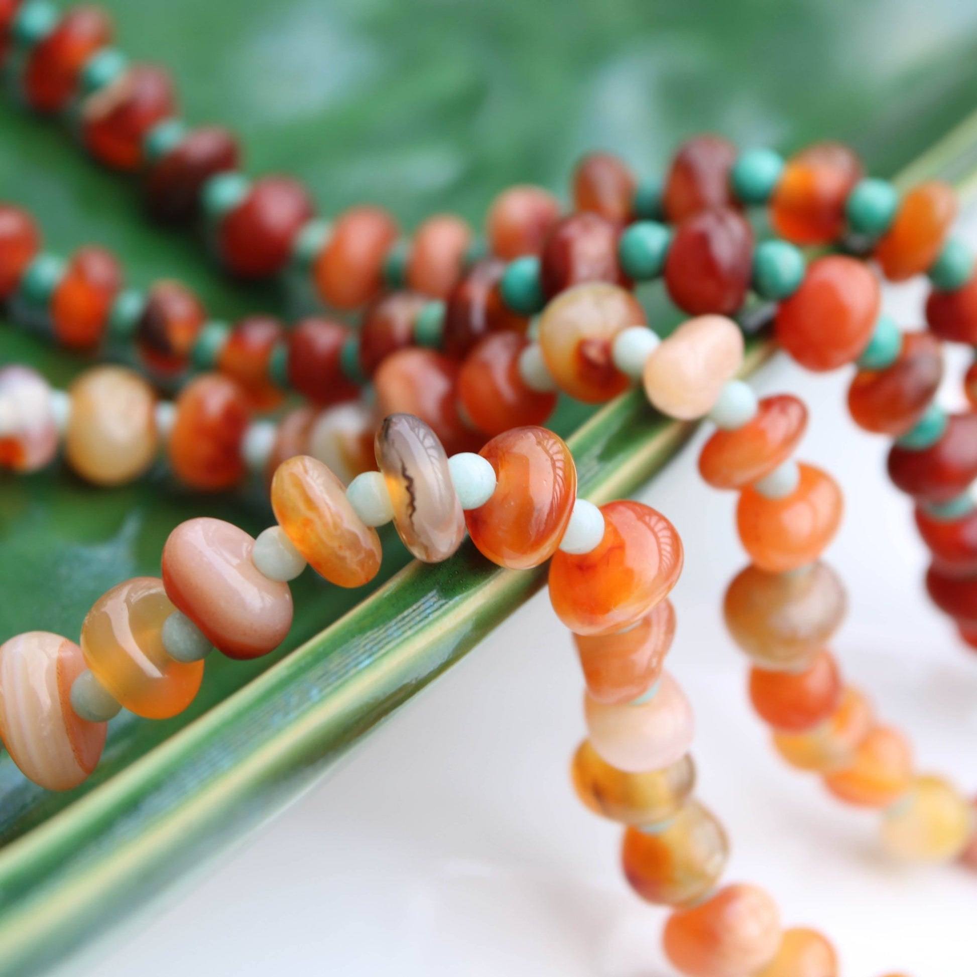 Light red botswana agate donut style beads accented with amazonite handmade in virginia carrie foscato design