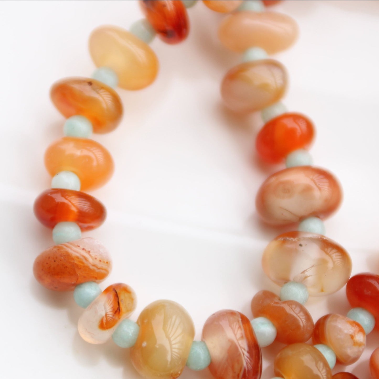 Light red botswana agate donut style beads accented with amazonite handmade in virginia carrie foscato design