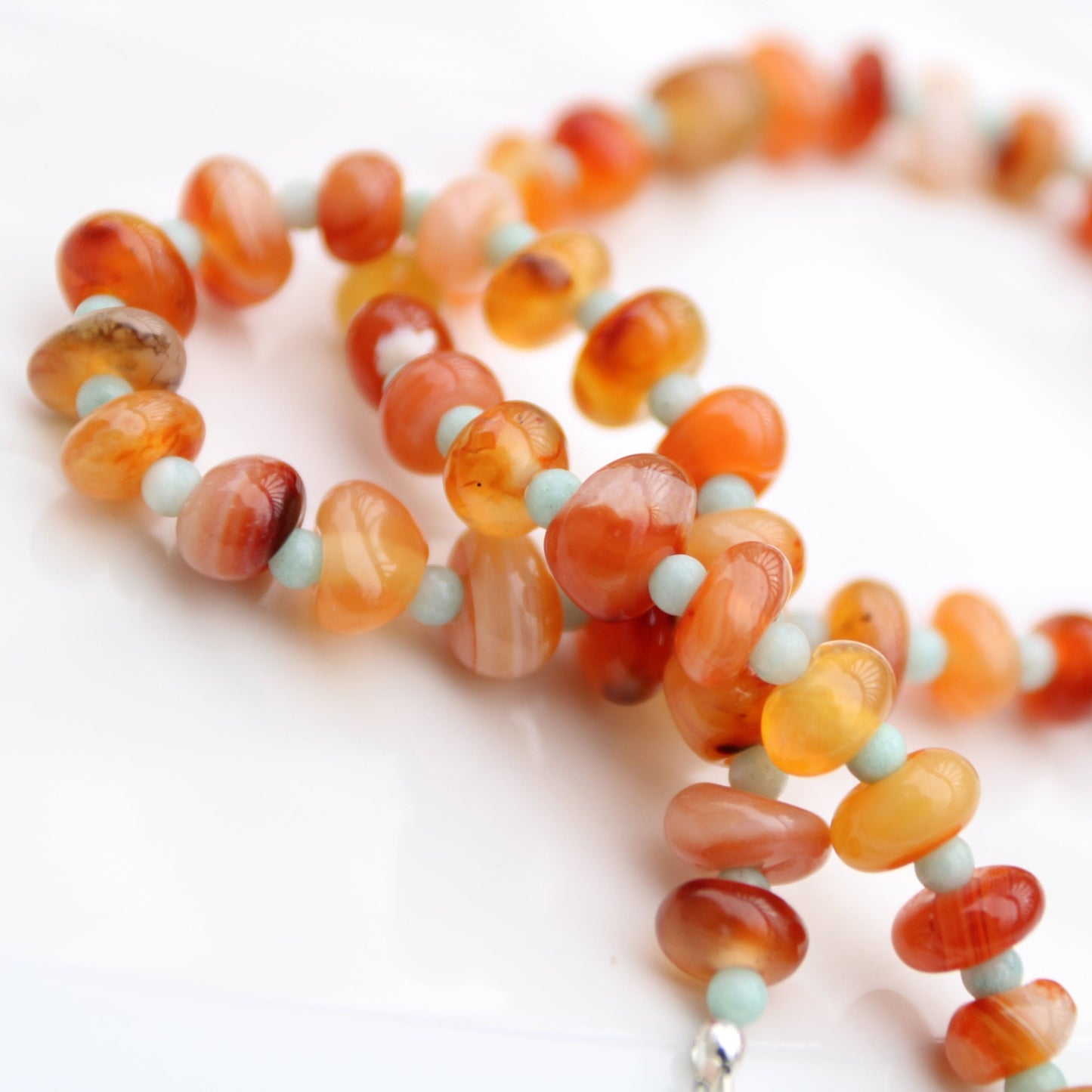 Light red botswana agate donut style beads accented with amazonite handmade in virginia carrie foscato design
