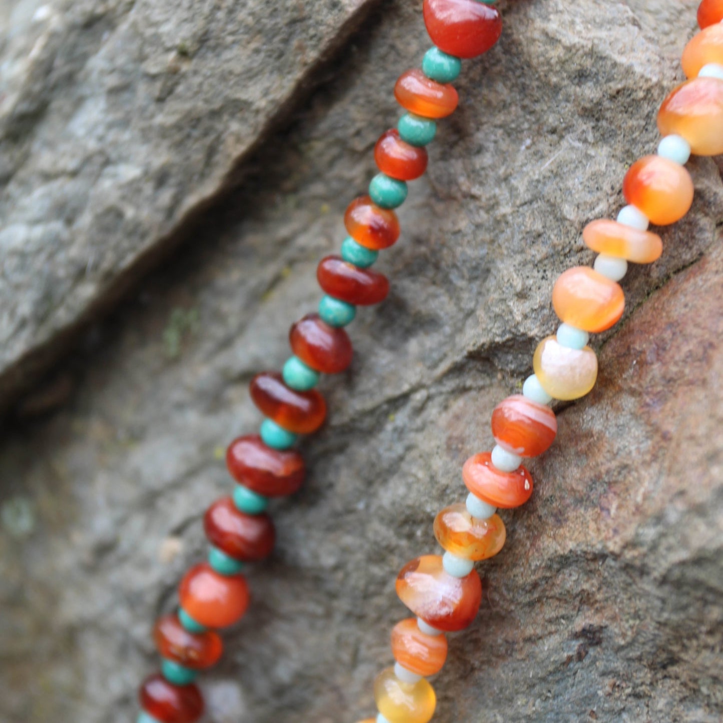 Light red botswana agate donut style beads accented with amazonite handmade in virginia carrie foscato design