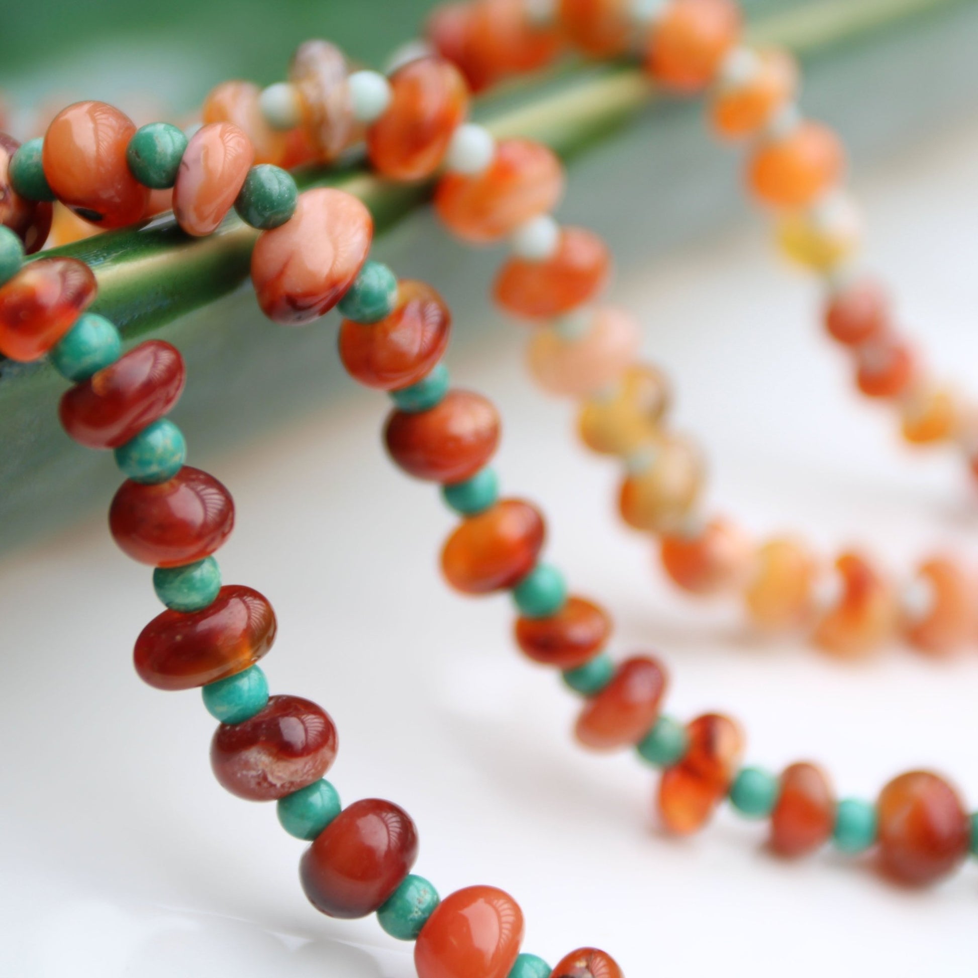 Light red botswana agate donut style beads accented with amazonite handmade in virginia carrie foscato design