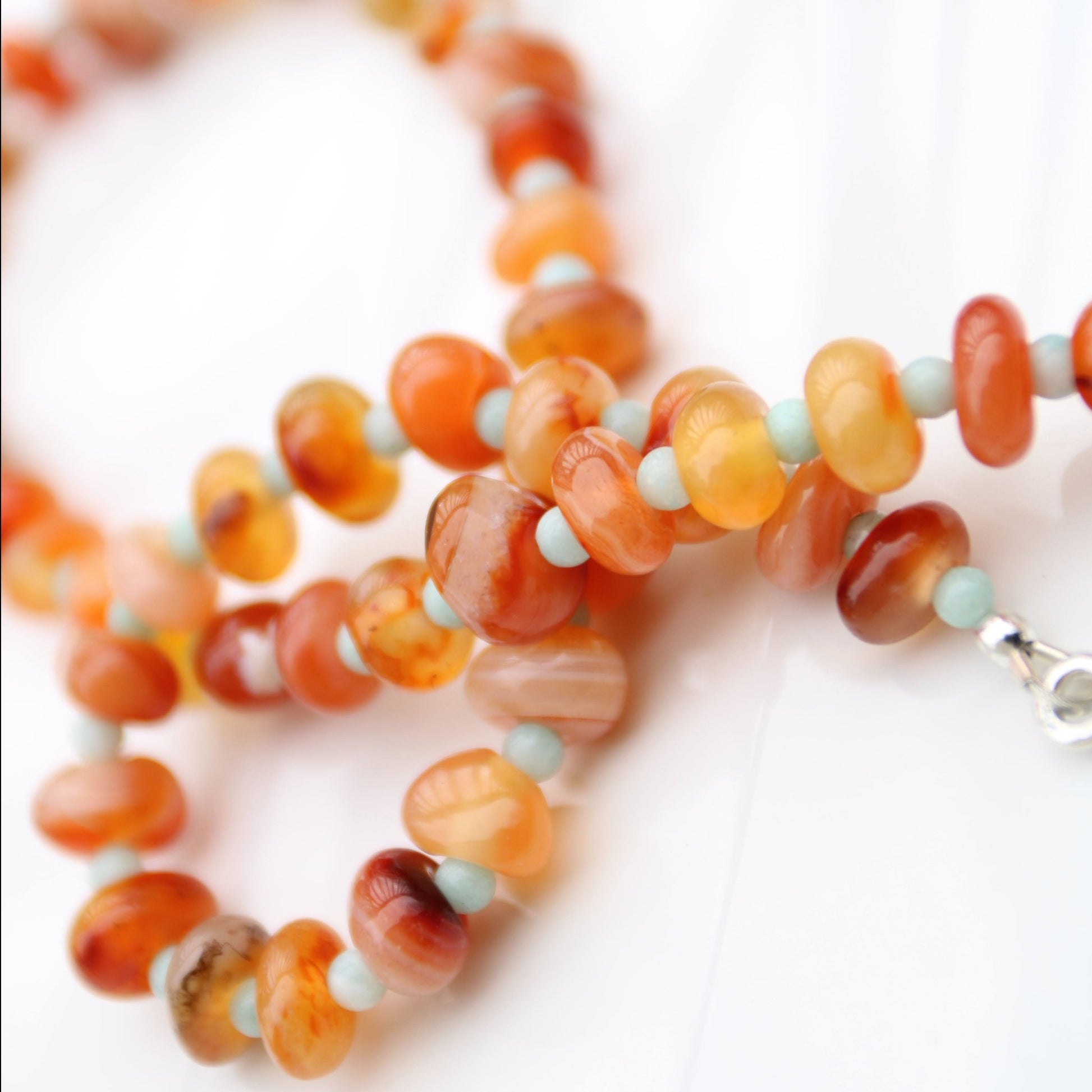 Light red botswana agate donut style beads accented with amazonite handmade in virginia carrie foscato design