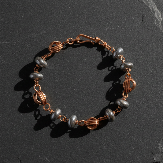 Copper bracelet flat lay on slate