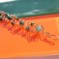 slinky wire wrapped copper cuff bracelet with green accent gemstones handmade carrie foscato design