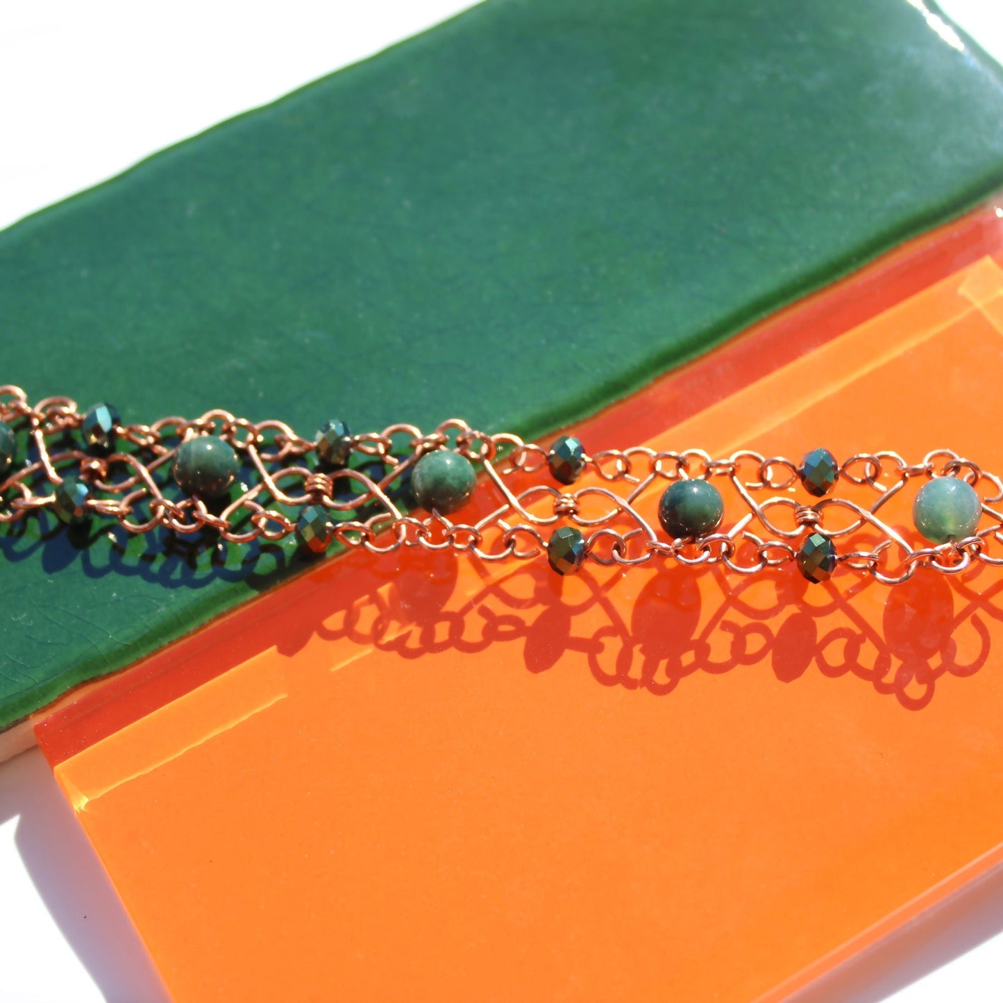 slinky wire wrapped copper cuff bracelet with green accent gemstones handmade carrie foscato design