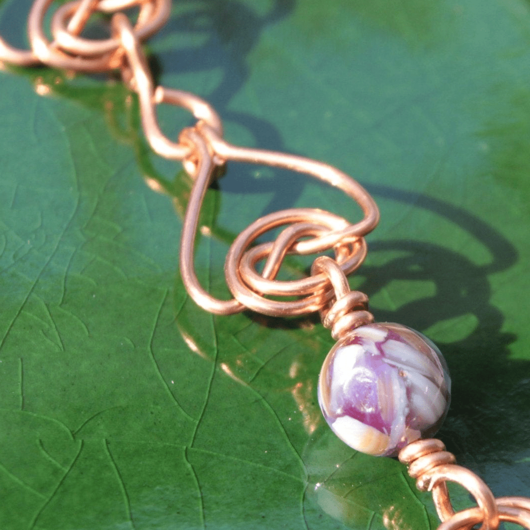 handmade double coin knot link bracelet that looks like woven hearts. Made in bare copper in the USA. Carrie Foscato Design