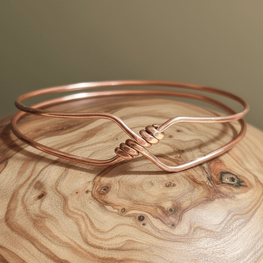 Copper bangle slid onto natural wood