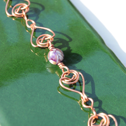 handmade double coin knot link bracelet that looks like woven hearts. Made in bare copper in the USA. Carrie Foscato Design