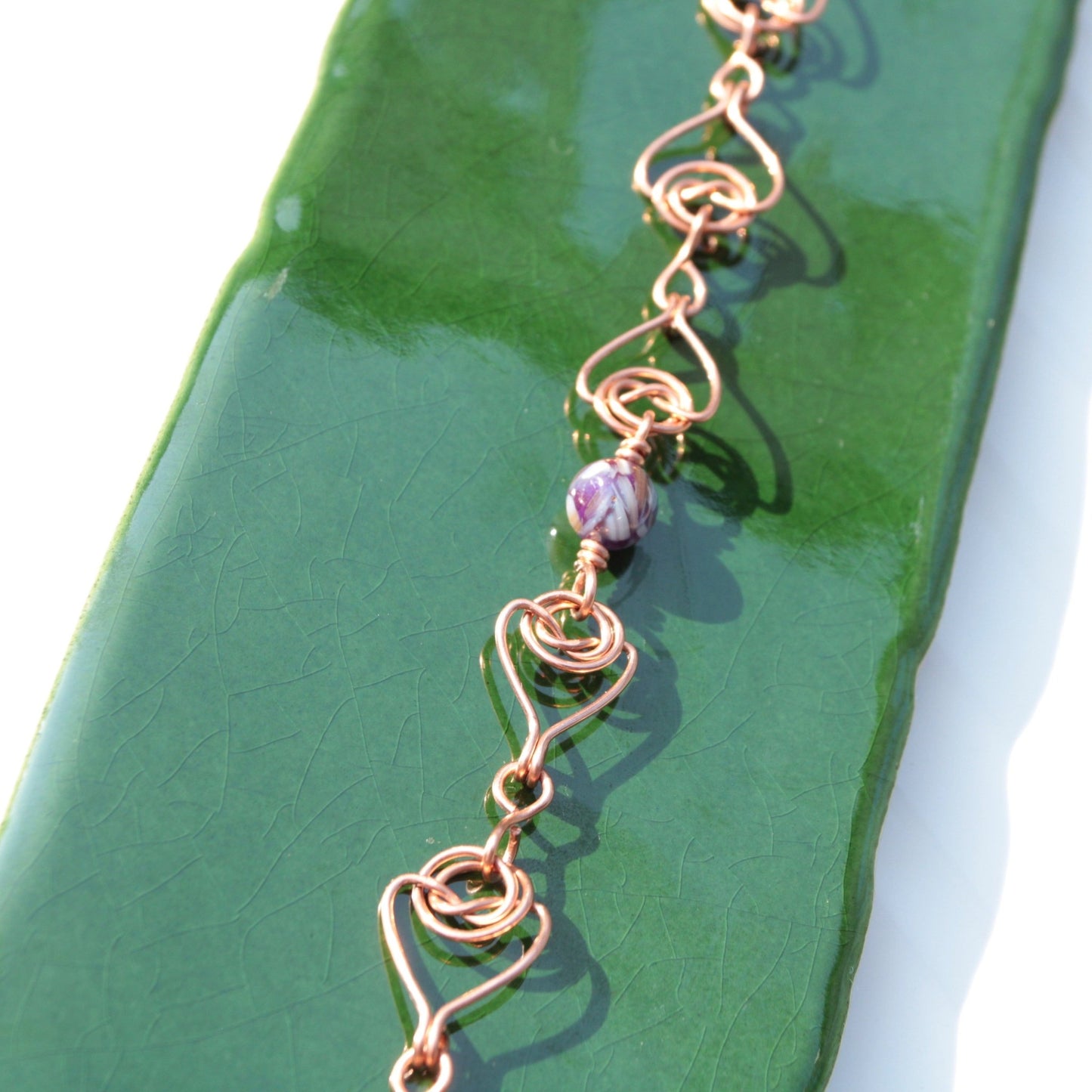 handmade double coin knot link bracelet that looks like woven hearts. Made in bare copper in the USA. Carrie Foscato Design