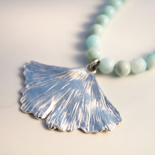 handmade fine silver ginkgo leaf pendant on a strand of aquamarine 8mm beads fasted with a sterling silver toggle clasp carrie foscato design made in USA