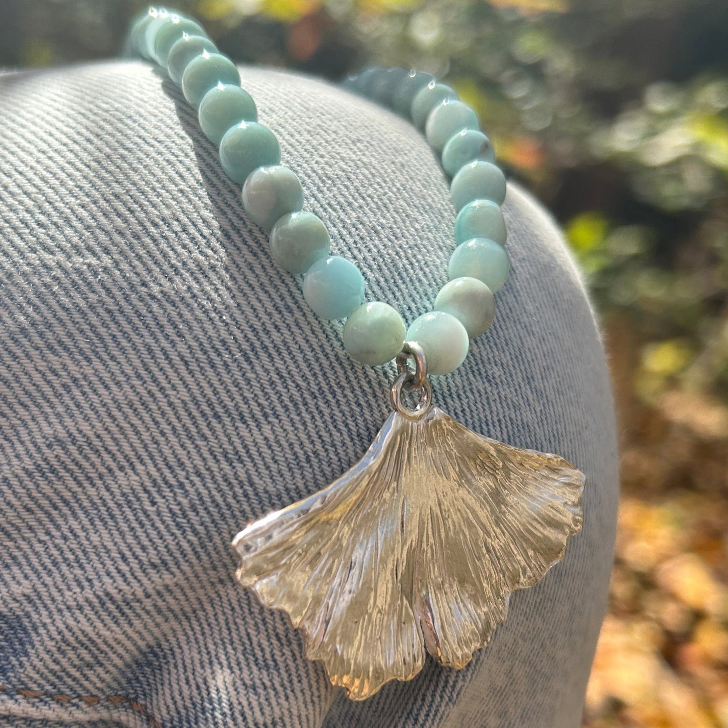 handmade fine silver ginkgo leaf pendant on a strand of aquamarine 8mm beads fasted with a sterling silver toggle clasp carrie foscato design made in USA