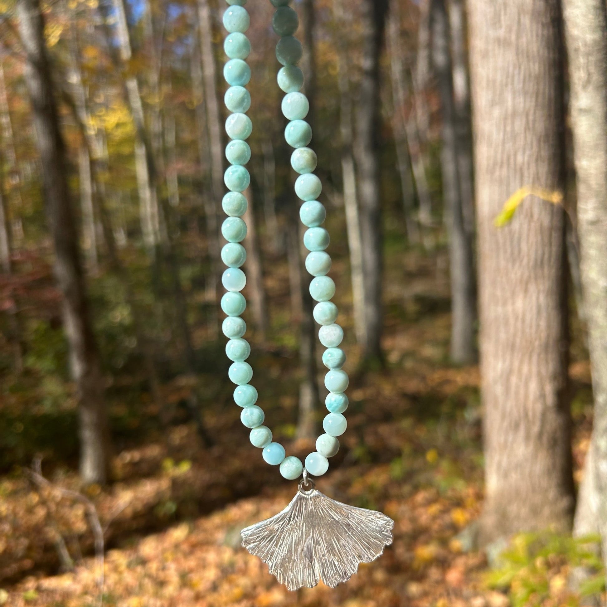 handmade fine silver ginkgo leaf pendant on a strand of aquamarine 8mm beads fasted with a sterling silver toggle clasp carrie foscato design made in USA