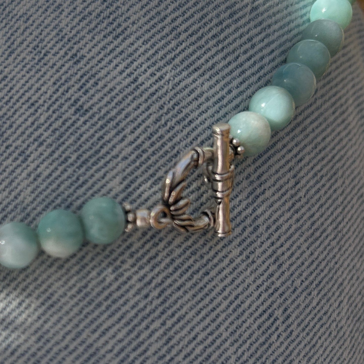handmade fine silver ginkgo leaf pendant on a strand of aquamarine 8mm beads fasted with a sterling silver toggle clasp carrie foscato design made in USA