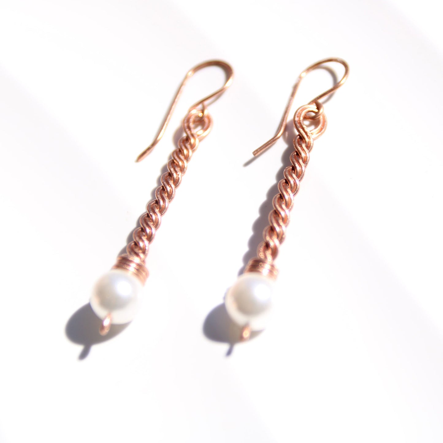 Handmade copper twist drop earrings with white freshwater pearl accents