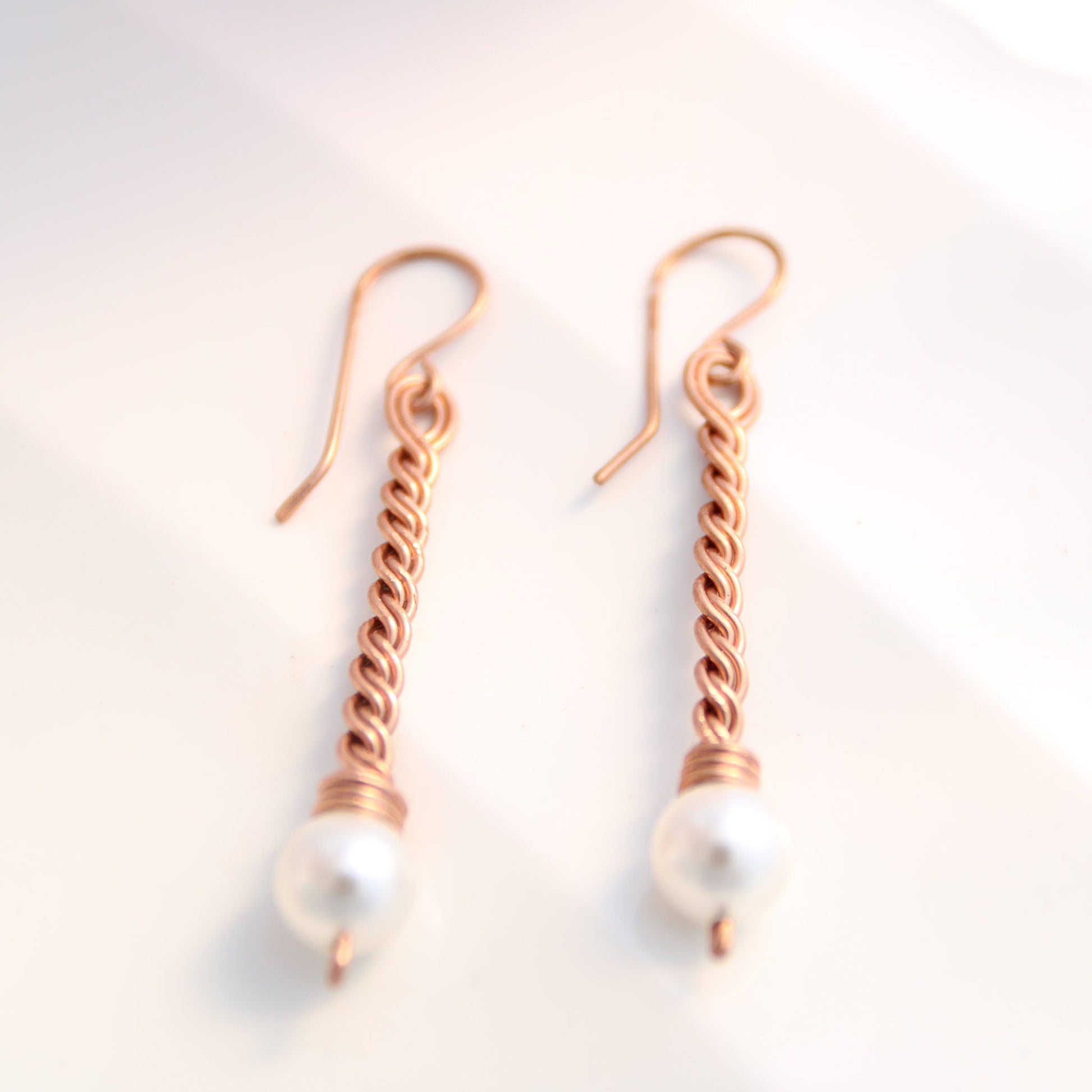 Handmade copper twist drop earrings with white freshwater pearl accents