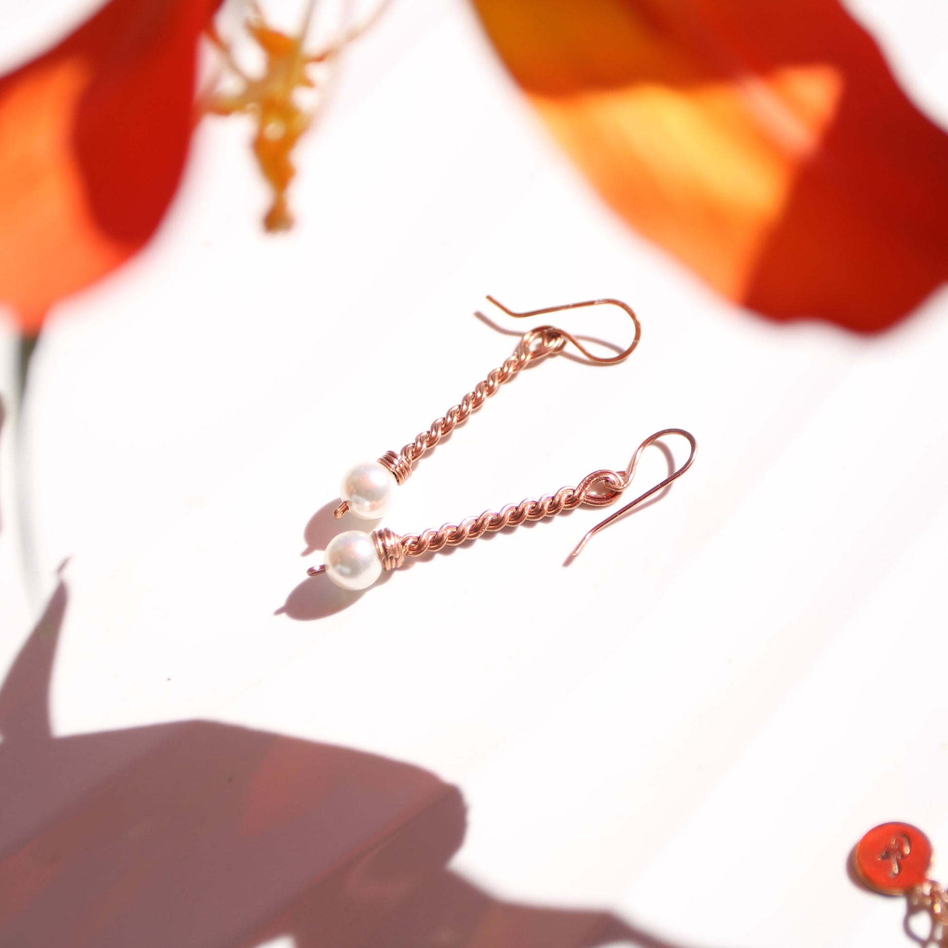 Handmade copper twist drop earrings with white freshwater pearl accents