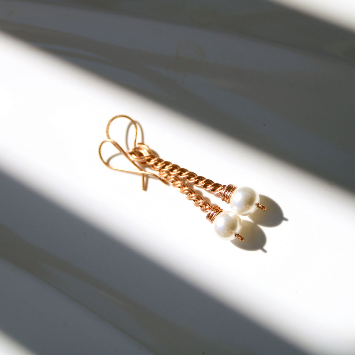 Handmade copper twist drop earrings with white freshwater pearl accents