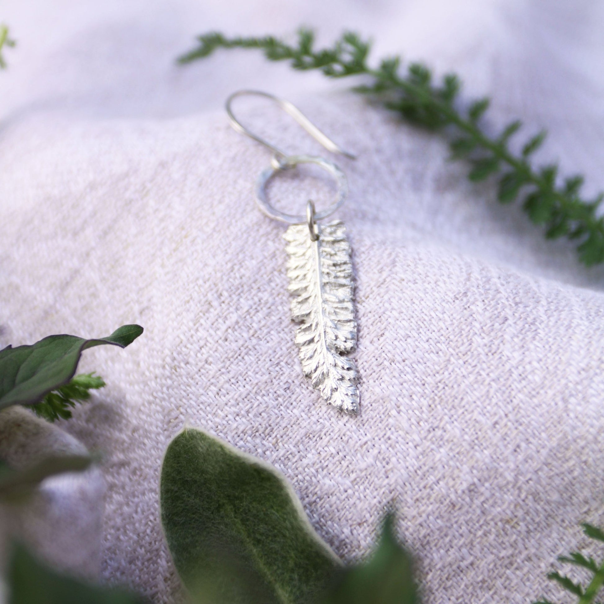 yarrow herb fine silver charm earrings on linen with herbs handmade carrie foscato design
