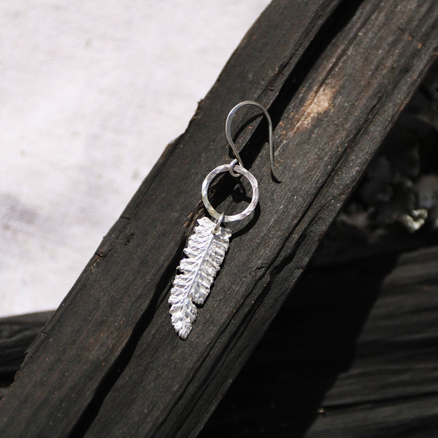yarrow fine silver charm herb earrings on dark wood handmade carrie foscato design