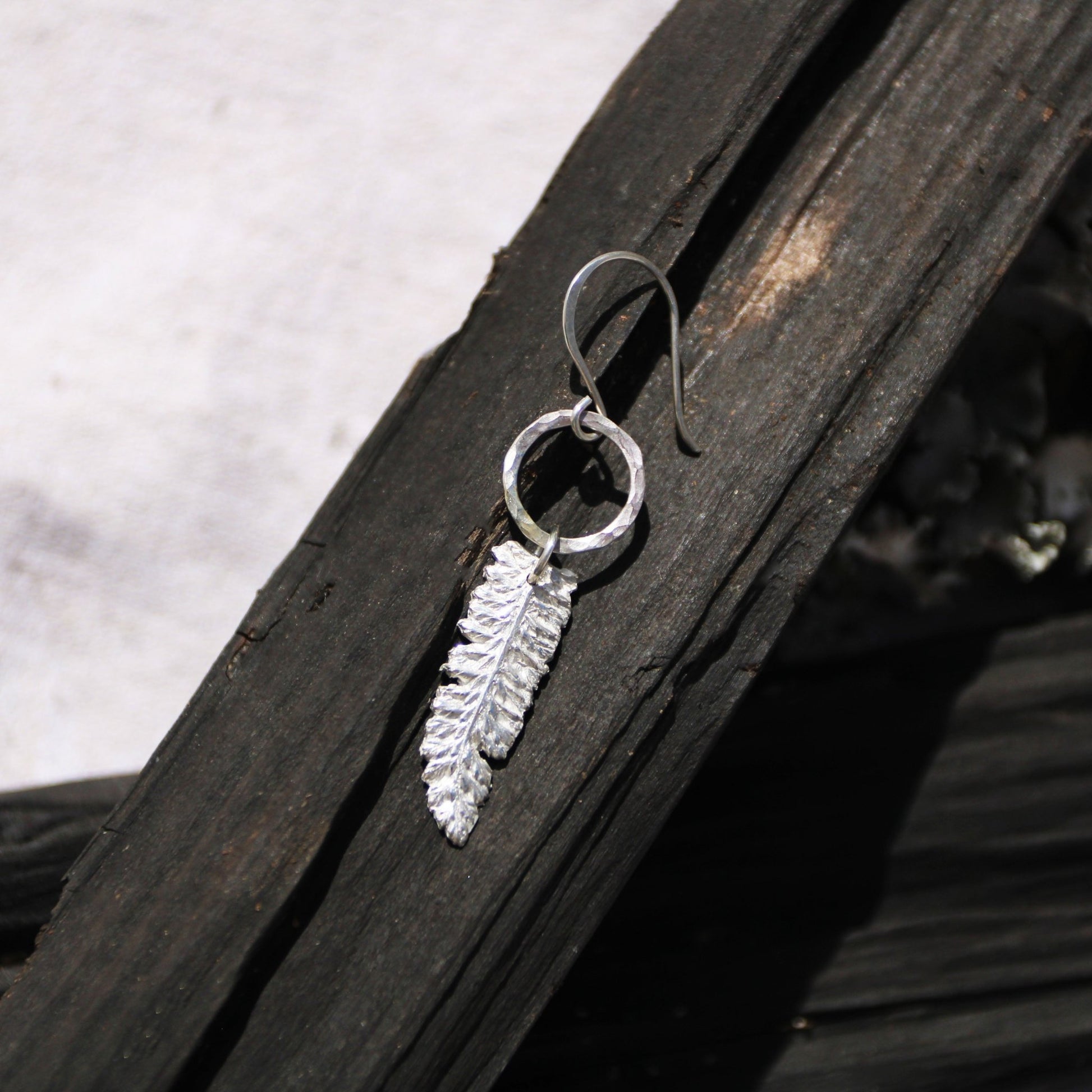 yarrow fine silver charm herb earrings on dark wood handmade carrie foscato design