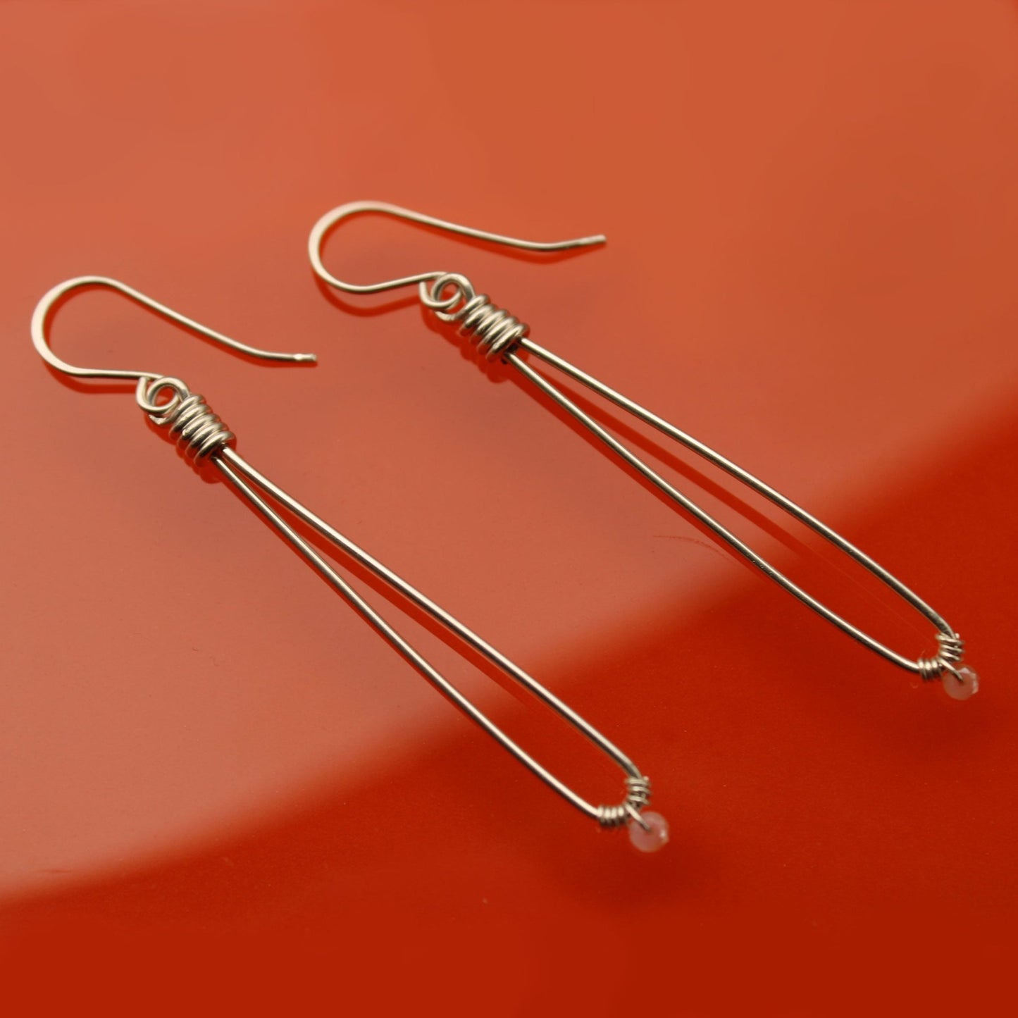 Sleek sterling silver long drop handmade earrings with rose quartz crystal beads carrie foscato design