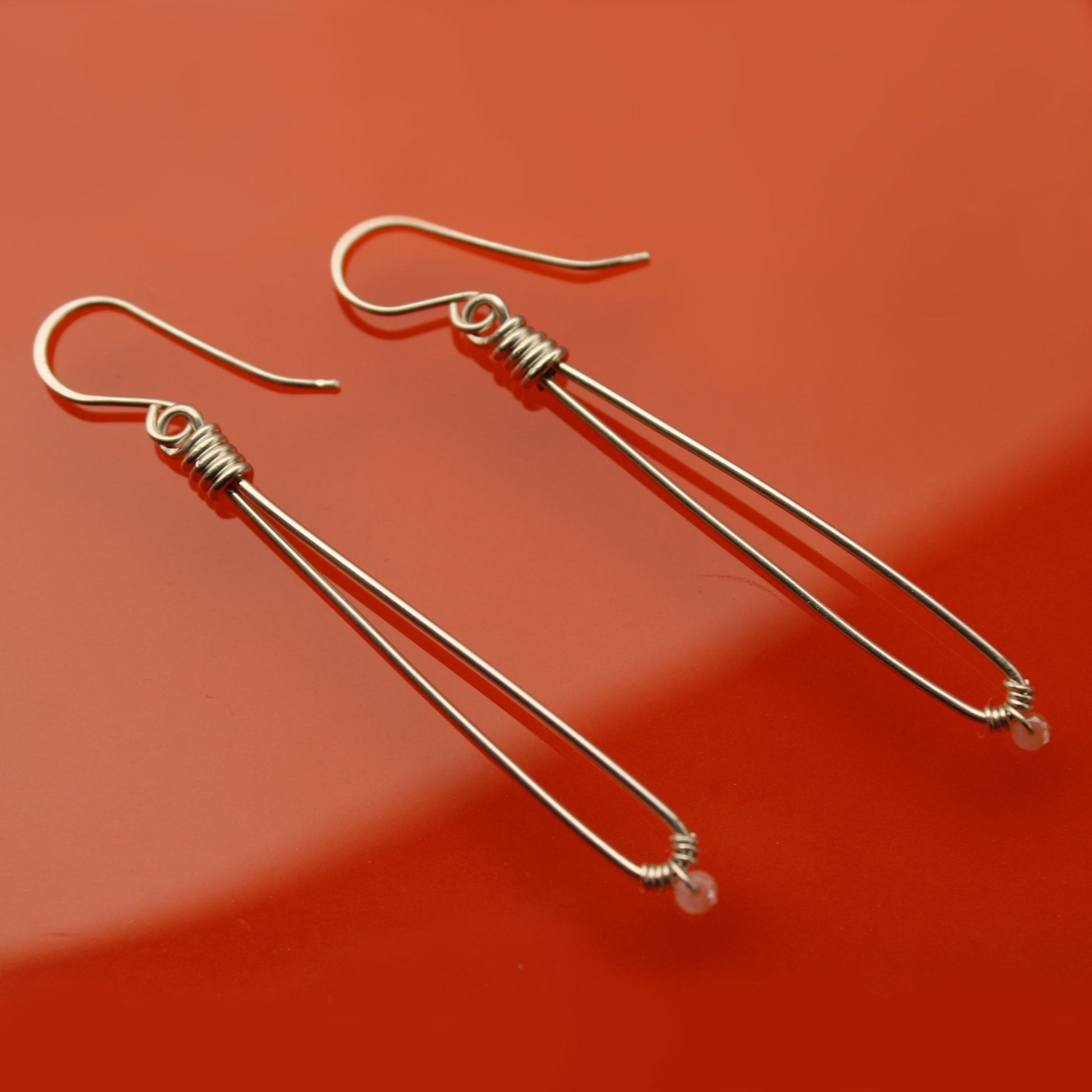 Sleek sterling silver long drop handmade earrings with rose quartz crystal beads carrie foscato design