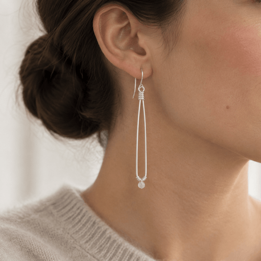 Luna Drop sterling silver earrings with a sleek bun and soft sweater