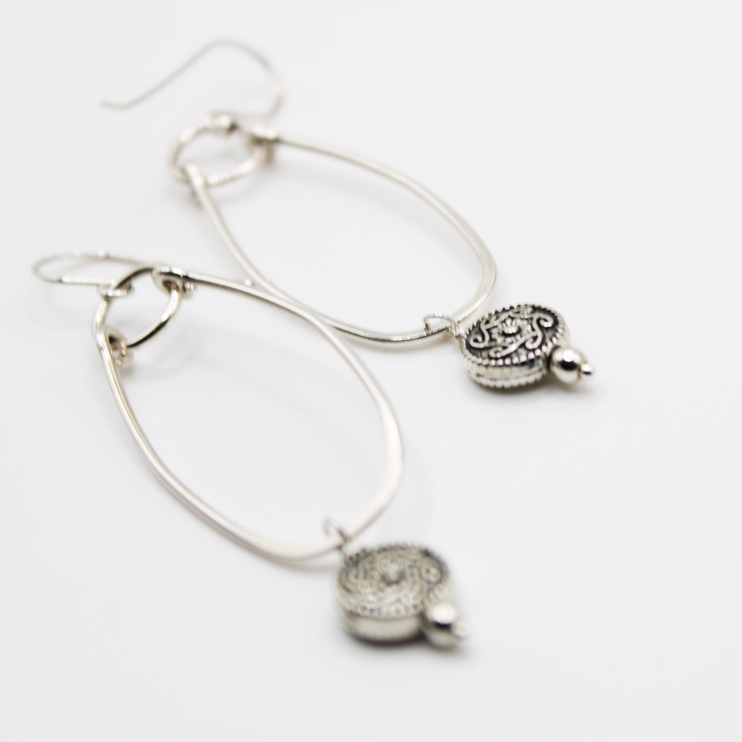sterling silver oblong hoop earrings with silver medallion accent bead