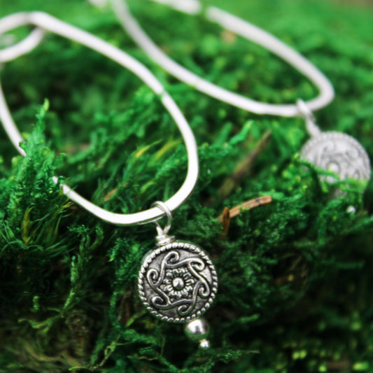 handmade sterling silver oblong earrings with silver medallion accent bead carrie foscato design USA