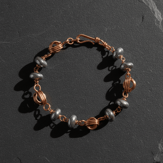 Copper bracelet flat lay on slate